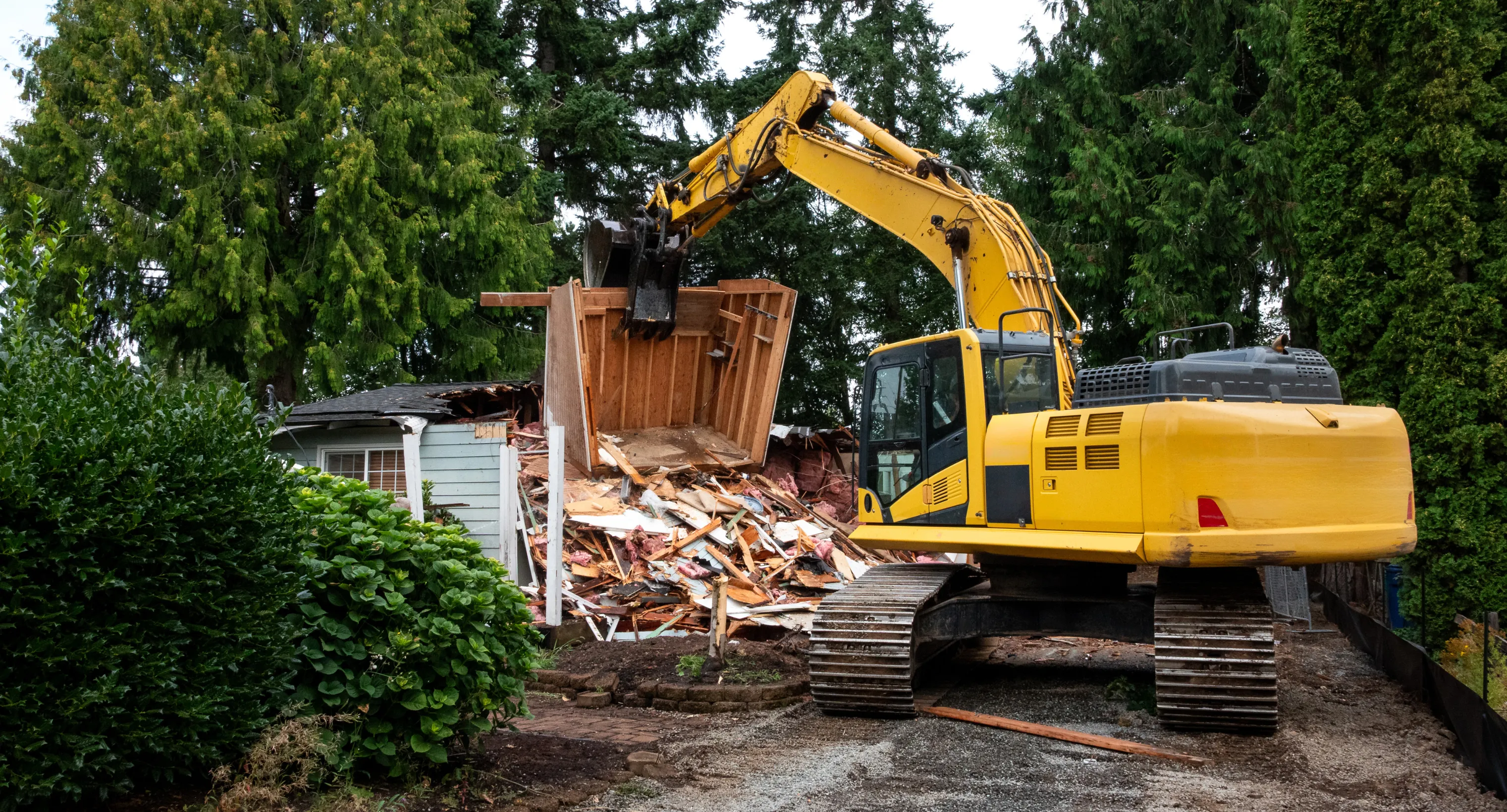 Demolition service in Dallas TX removing an existing structure with professional excavation equipment